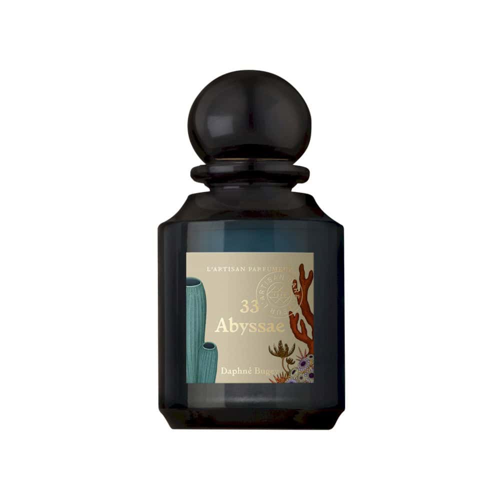 Blue bottle of Abyssae perfume with sea elements and corals on the label, by Daphne Bugey