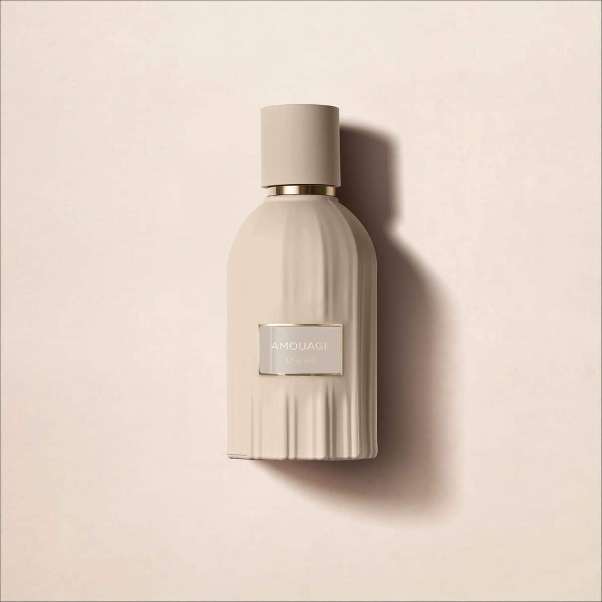 Amouage Line 618 perfume bottle, elegant ribbed beige design with gold accents