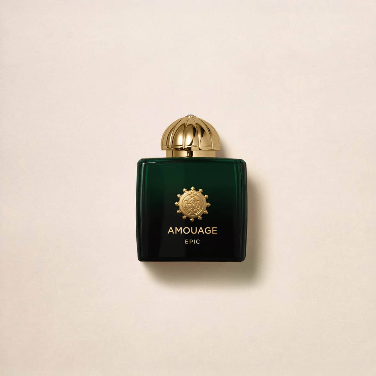 Amouage Epic Woman Eau de Parfum, a luxurious green bottle with a gold cap and emblem.