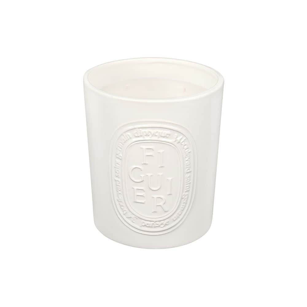 White Diptyque fig candle with embossed "FIGUIER" label