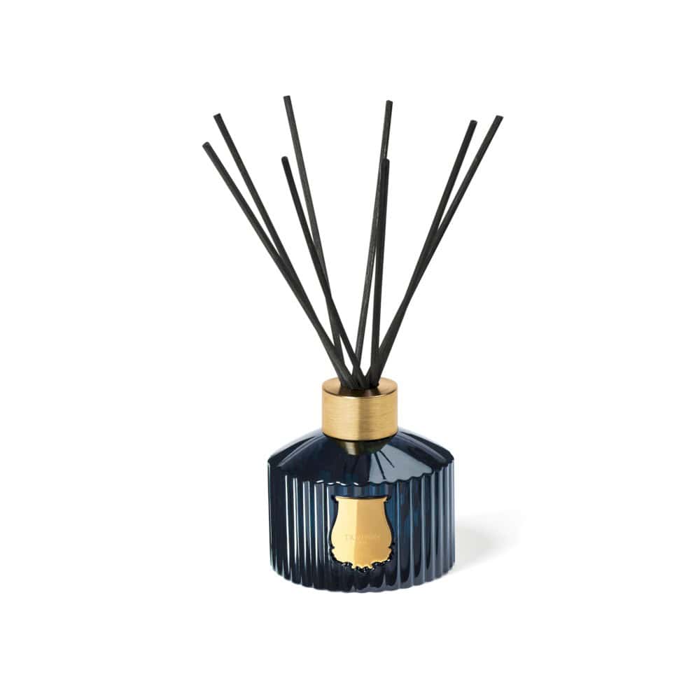Reggio Diffuser: Dark blue glass reed diffuser with gold accents and black reeds