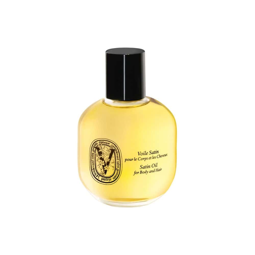 Diptyque Satin Oil for Body and Hair in a clear glass bottle with a black cap