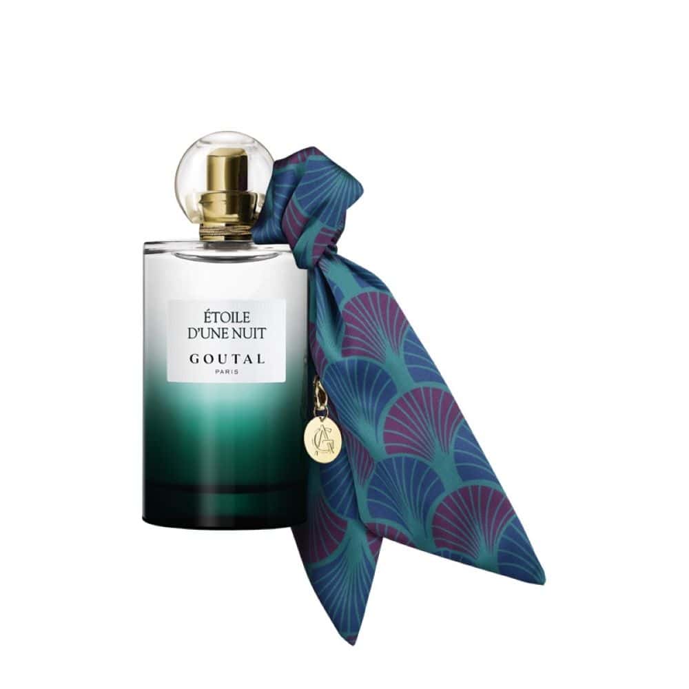 Goutal Paris Étoile d’une Nuit perfume bottle with a decorative silk scarf and gold charm