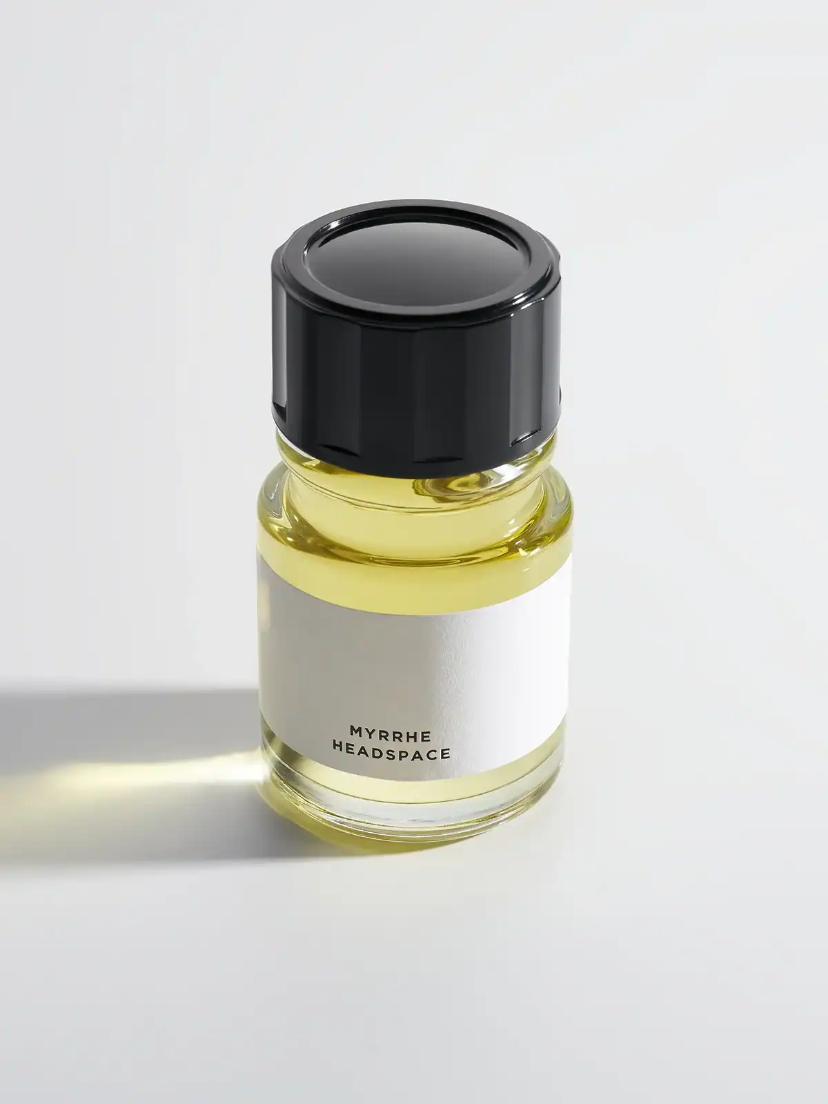 Clear glass bottle of Myrrh Headspace fragrance oil with black cap and white label
