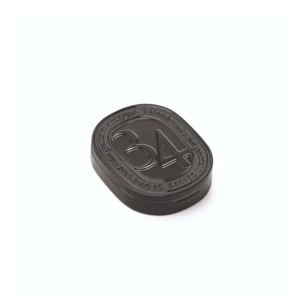 Diptyque 34 solid perfume compact with embossed logo
