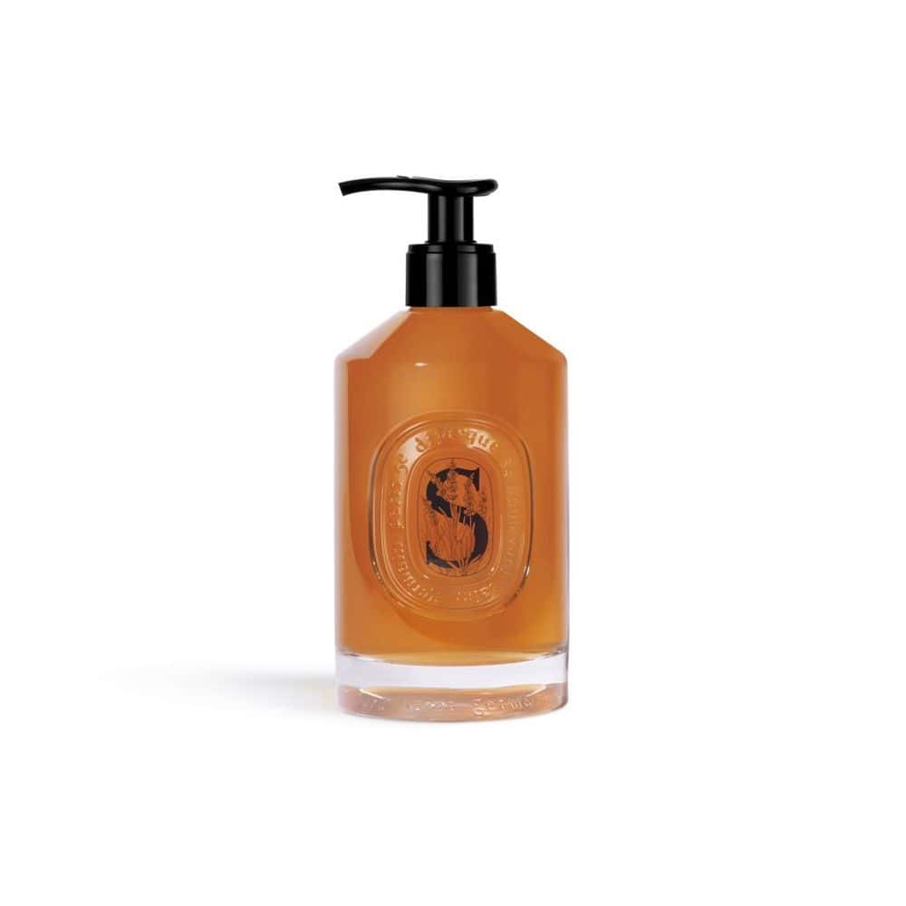 Diptyque Softening Hand Wash in amber liquid with black pump dispenser and oval label
